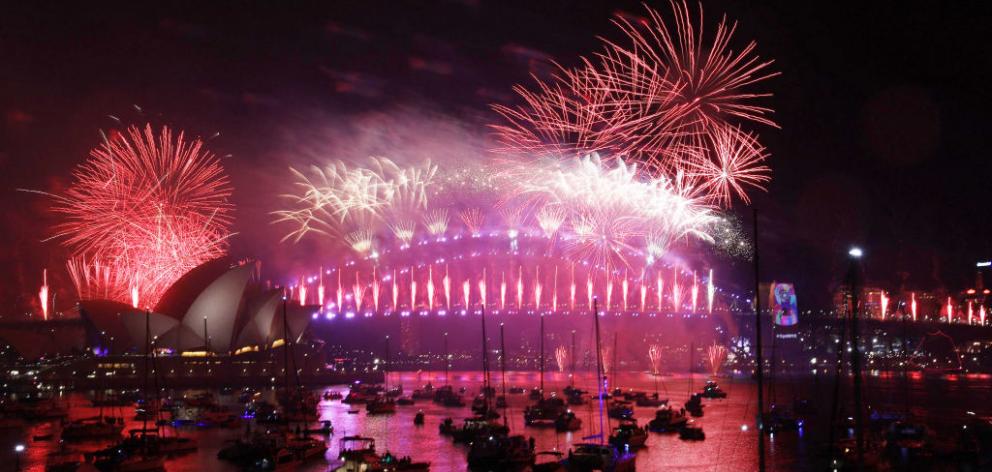 Fireworks explode over the Sydney Harbour Bridge during the New Year's celebrations. Photo: Getty...