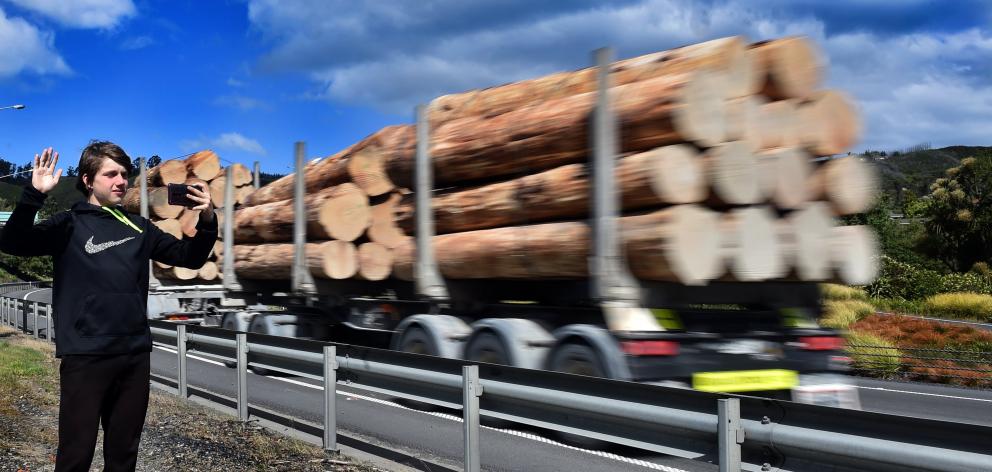 Robert Hoover (14) takes a photograph of a passing truck  on  State Highway 1 at Mosgiel...