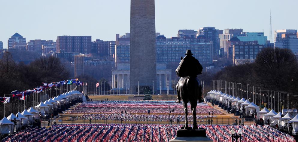 Thousands of US flags at the National Mall representing people unable to travel to Washington for...