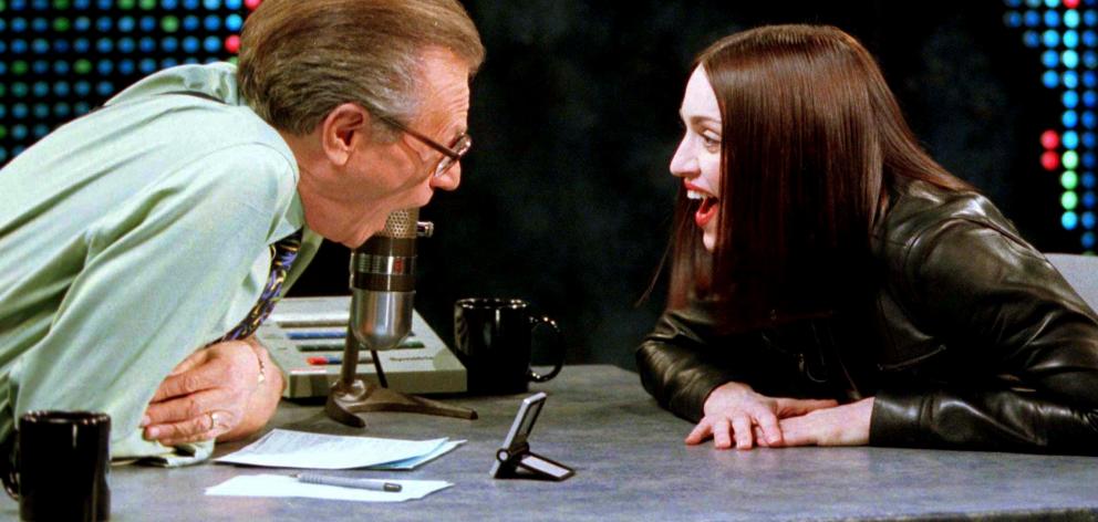 Singer and actress Madonna shares a laugh with Larry King in 1999. Photo: Reuters