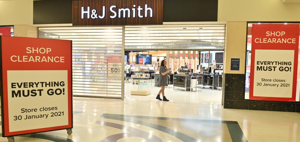 H&J Smith retail assistant Sophie Smith closes the door on the Dunedin store for the final time...