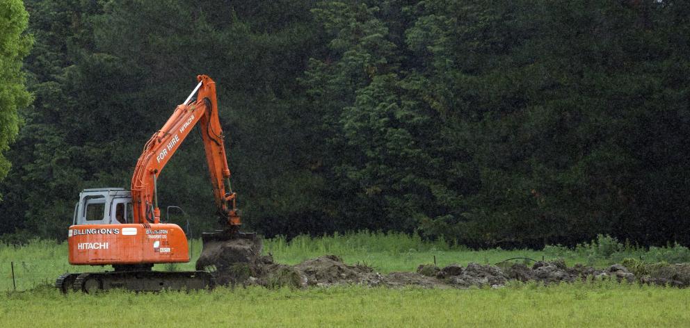 A digger keeps a water channel clear by Gladbrook Rd, Middlemarch. PHOTO: CHRISTINE O’CONNOR

