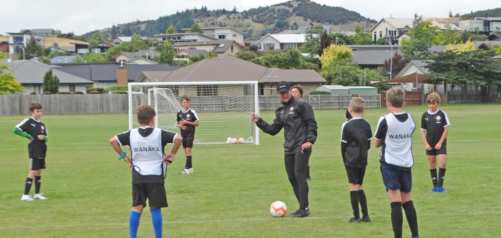 Ole Football Academy Technical Director Ben Sippola coaches a group of youngsters at the Wanaka...