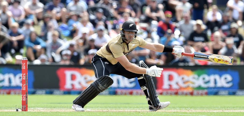 Opener Martin Guptill plays an ungainly shot on his way to top-scoring with 97, laying the...
