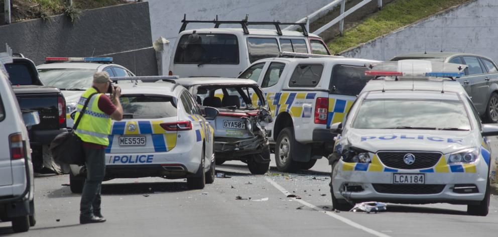 A police photographer takes photos at the scene of a car crash which left a police dog injured...