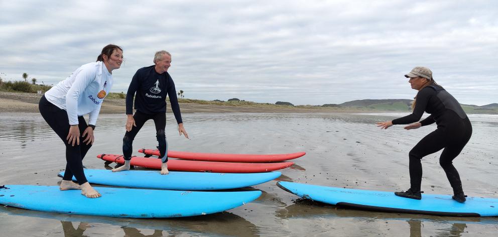 Southland Surf School director Jess Terrill (right) teaches sheep and beef farmer Victoria Baker, of Stag Valley in Mossburn and dairy farmer Bryan Clearwater, of Scott’s Gap at Surfing for Farmers at Colac Bay. Photo: Katrina Thomas