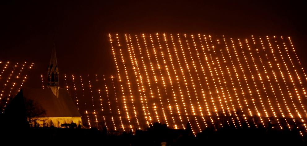 Heaters are lit early in the morning to protect vineyards from frost damage outside Chablis, France. Photo: Reuters