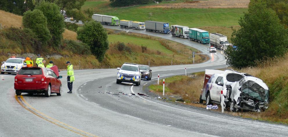 Police review the scene of a three-car crash on State Highway 1 near Lovells Flat yesterday...