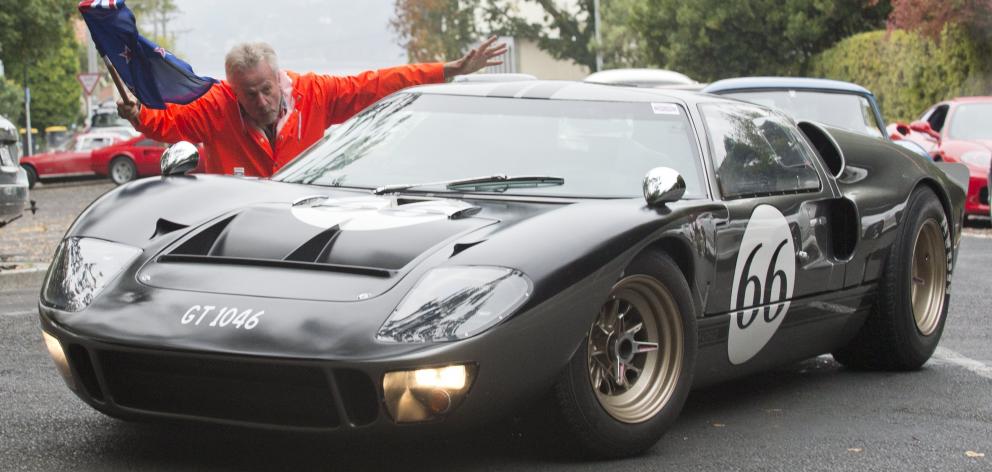 Dunedin city councillor Lee Vandervis flags away Brian Stewart in his Ford GT40 replica.