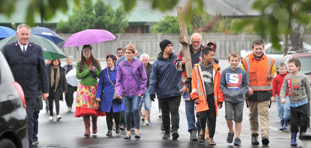 Stephen Macey carried the cross and was joined by about 30 people on a walk in Mosgiel this...