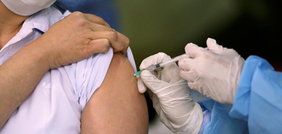 A Pfizer-BioNTech Covid-19 vaccine is administered as part of the global vaccine rollout. Photo:...