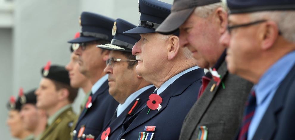 Volunteer firefighter Gordon Munn (centre) in a line of other servicemen on parade at the...