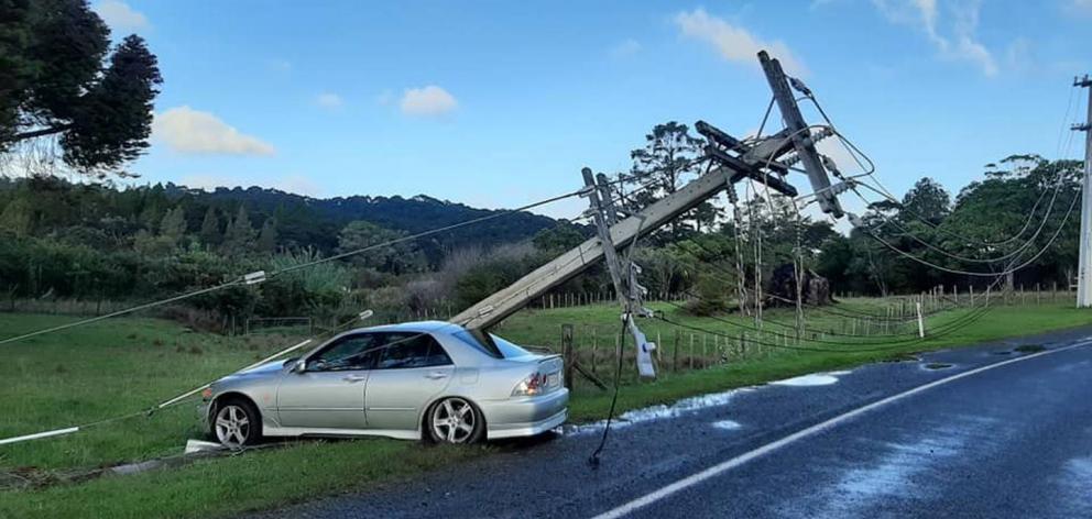 The pole crushed the rear passenger's compartment and took off the driver's door. Photo / Laingholm Volunteer Fire Brigade