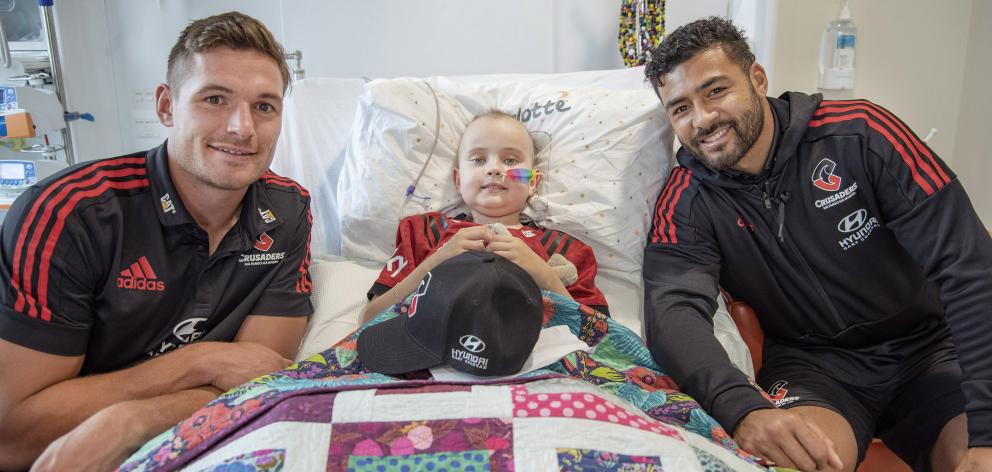George Bridge and Richie Mo’unga with patients at the Children’s Haematology and Oncology Centre....
