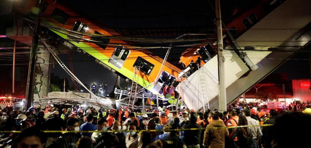 Rescuers work at a site where an overpass for a metro partially collapsed with train cars on it at Olivos station in Mexico City. Photo: Reuters