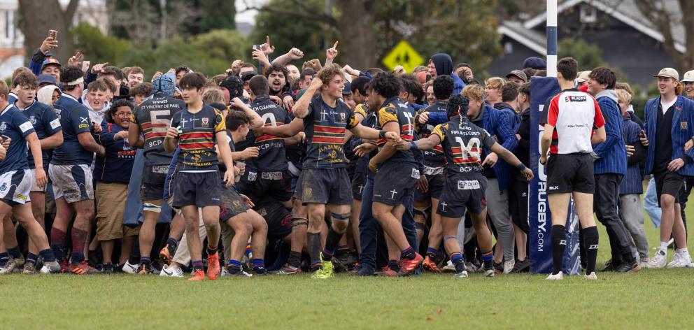 St Thomas of Canterbury College players and students celebrate a late go-ahead try against St...