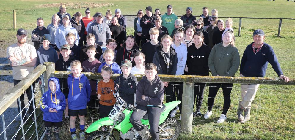 Lawrence Gymkhana Club president Paul Wilson stands at the right of a group demonstrating the depth of support from local families for the facility’s motocross track, on Saturday. PHOTO: JOHN COSGROVE