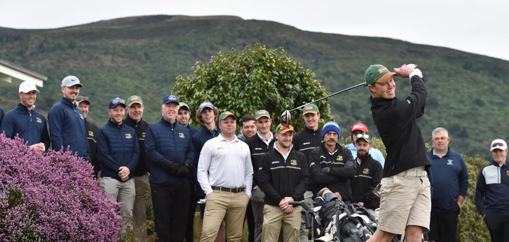 The two teams representing the Otago Golf Club, the B52s and the Bombers, watch as Callum Judkins...