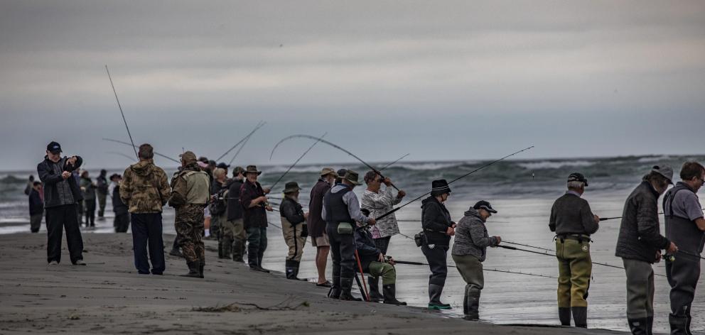 Entrants in the Rangers Fishing Competition line the banks of the river mouth. Photo: Richard...
