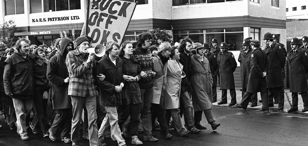 John Minto  speaks into a megaphone as he leads an anti-Springbok tour march in Dunedin in 1981....