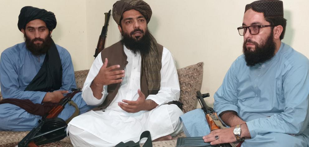 Waheedullah Hashimi (centre) says the Taliban would  fully implement its version of sharia, or...