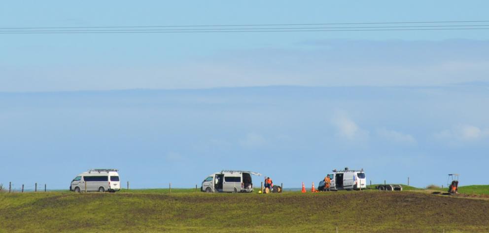 Contractors work to temporarily replace the damaged section of fibre cable that left more than...