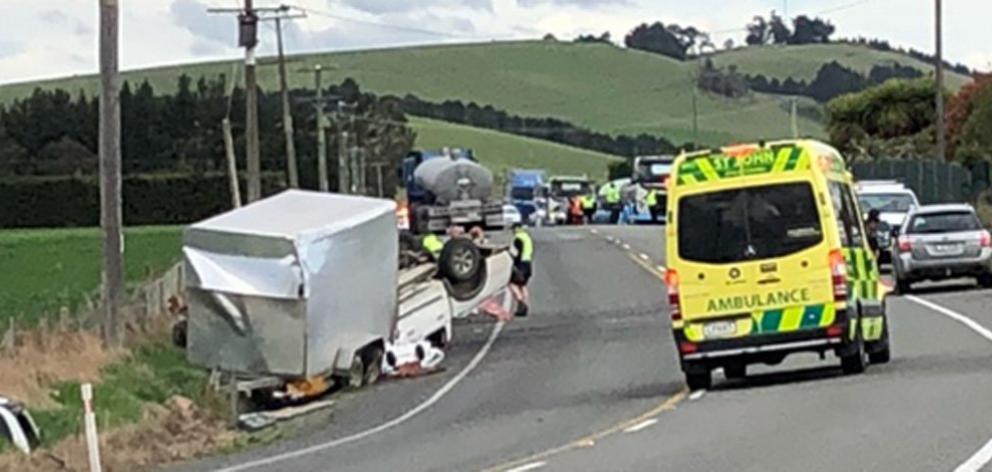 An ambulance attends a two-vehicle crash on State Highway 1 near Herbert yesterday afternoon,...