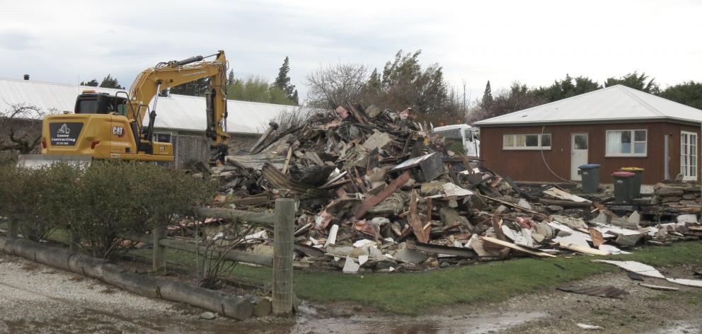 An excavator finishes demolishing The Bank Ophir after it was gutted by fire yesterday. PHOTO:...