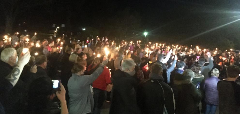 Hundreds attend a vigil led by Timaru Hospital chaplain Alan Cummins (below) for three girls...