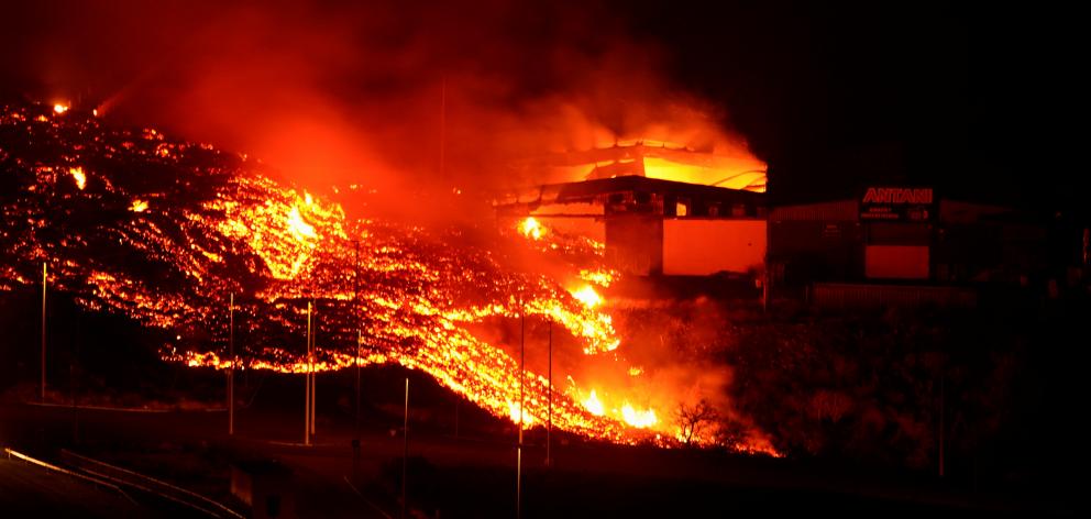 Lava burns buildings following the eruption of the Cumbre Vieja volcano. Photo: Reuters