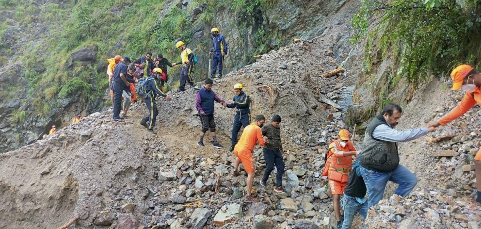 Stranded people were helped from landslides at Chhara village in Nainital district, in the...