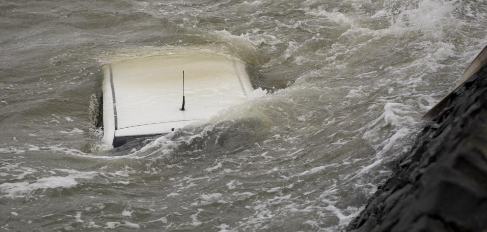 Firefighters secured a car in the choppy Otago Harbour near Glenfalloch this morning. Photo: Gerard O'Brien Firefighters secured a car in the choppy Otago Harbour near Glenfalloch this morning. Photo: Gerard O'Brien