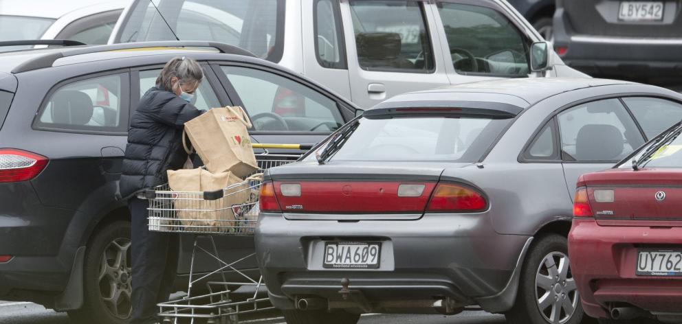  A supermarket shopper loads groceries into her car at Countdown Dunedin Central yesterday...