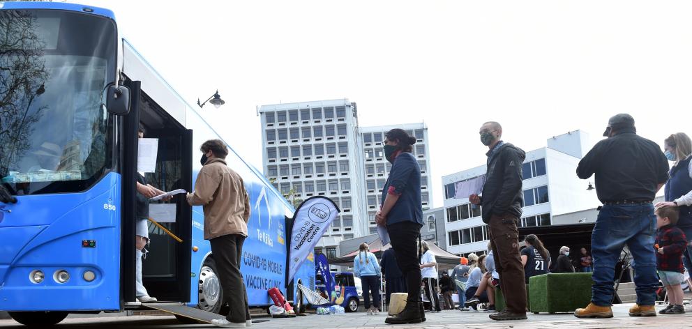 People queue for the vaccine bus in the Octagon in Dunedin. PHOTO: PETER MCINTOSH