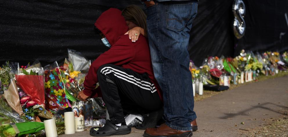 People lay flowers during a visit to a makeshift memorial for the concertgoers who died in a stampede during a Travis Scott performance in Houston, Texas. Photo: Reuters