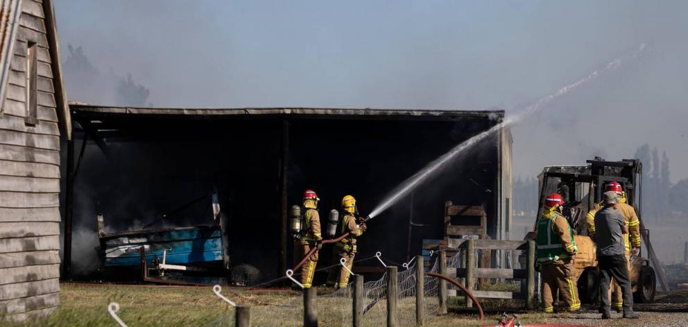 Firefighters tackle a large blaze at Lincoln that claimed two sheds. Photo: George Heard