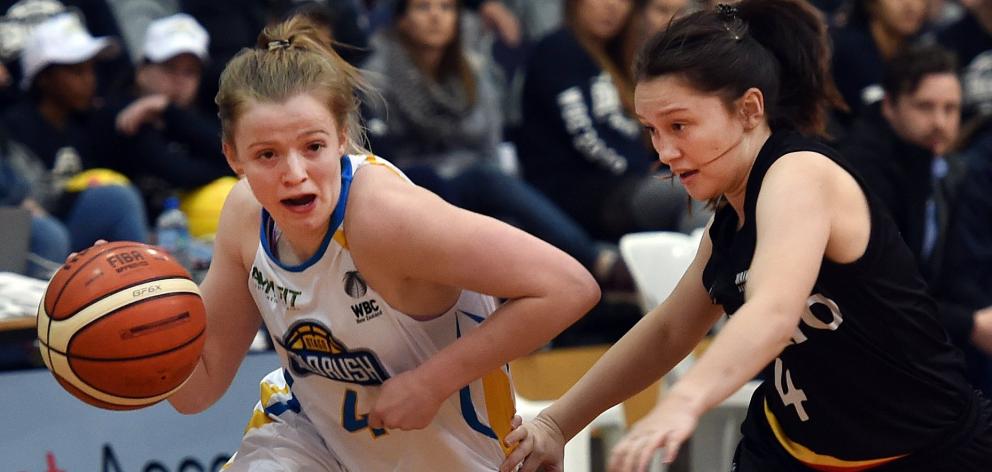 Aleisha Ruske dribbles the ball for the Otago Gold Rush in 2019 as Quaye Walker-Eketone of the...