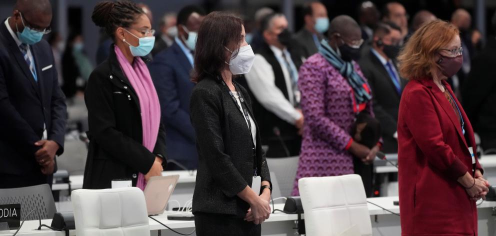 Delegates observe a one-minute silence for the victims of the Covid-19 pandemic during the...