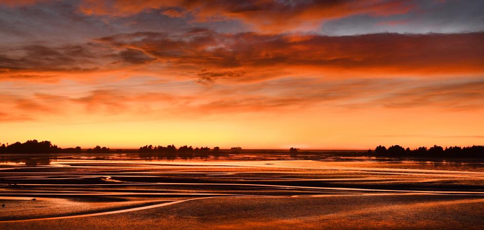 The sun rises at Blueskin Bay, north of Dunedin. Photo: Stephen Jaquiery