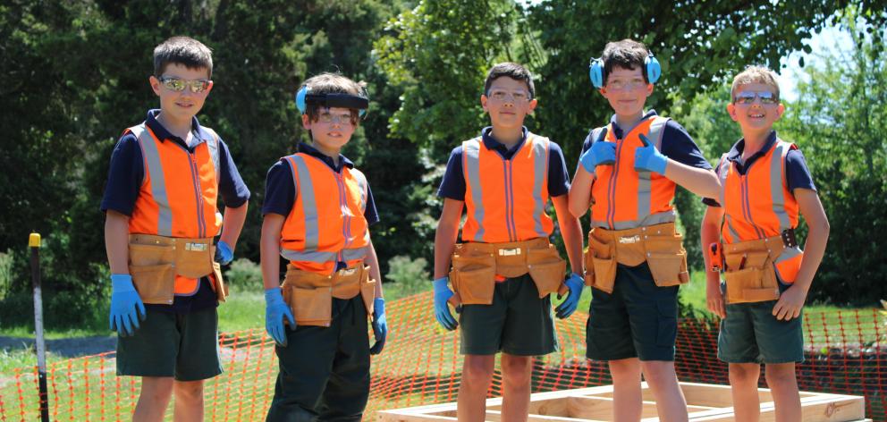 Oscar (left), Ollie, Rylan, Joel and Bjorn suited up in their PPE gear for a working bee. Photo:...