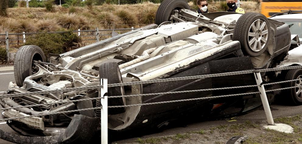 The passengers of the overturned car walked away without major injuries. Photo: Geoff Sloan