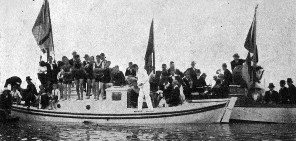 Onlookers crowd moored yachts while watching the Karitane Regatta on December 27, 1921. — Otago...