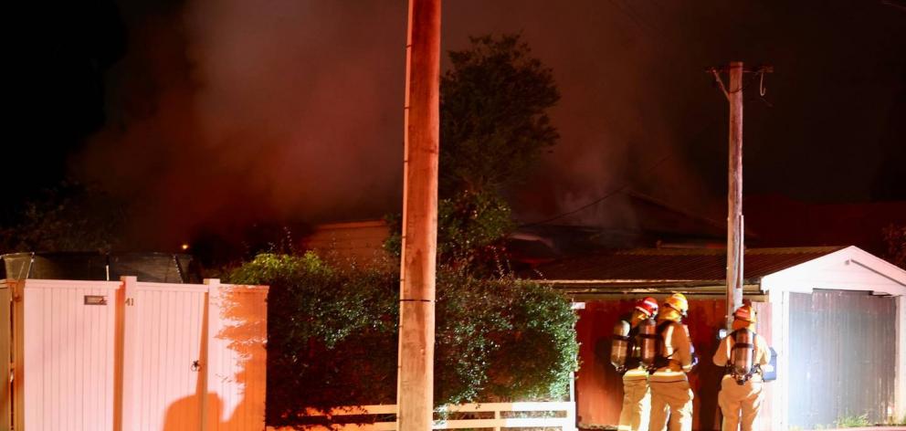Firefighters battled a well-involved fire at a house in Sydenham last night. Photo: George Heard ...