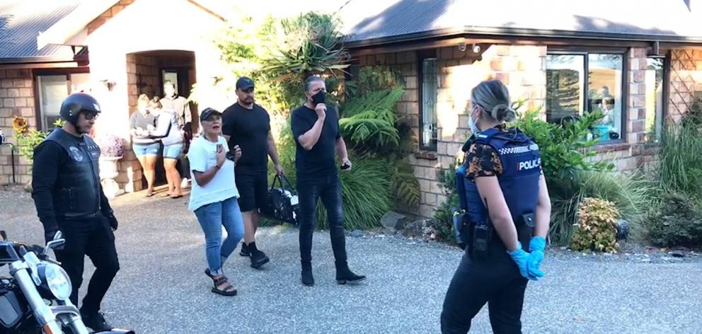 Hannah and Brian Tamaki emerge from their house this morning as police arrest Brian Tamaki -...