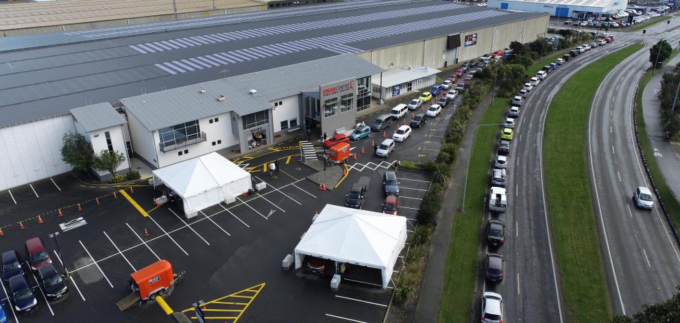 People queue around the block for the Covid-19 vaccination at one of the Te Kaika drive-through...