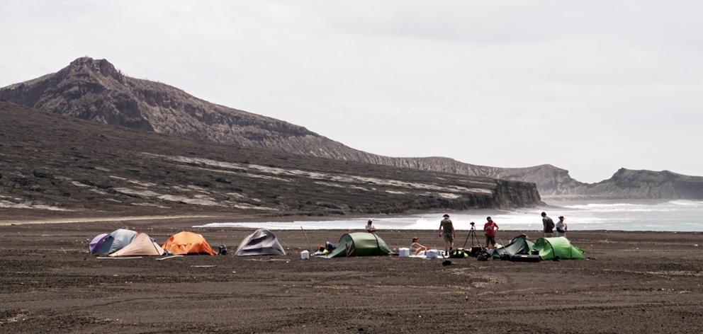 A scientific expedition set up camp on loose rock from the 2014-15 eruption near the cliffs of...