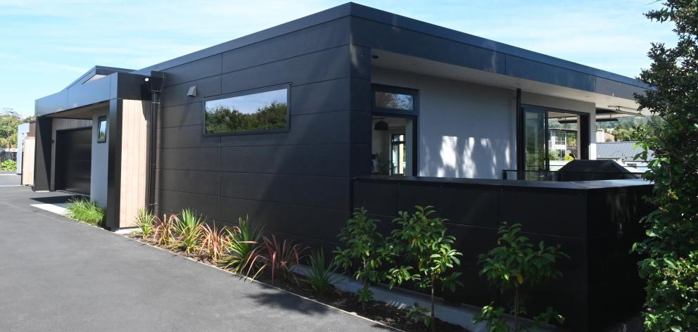 Dark cladding contrasts with cedar on the exterior.
