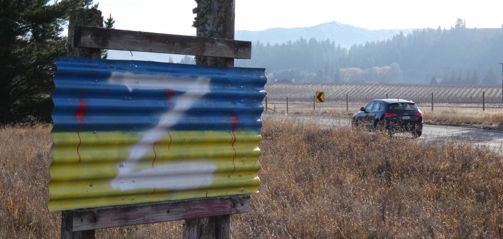 The letter Z added to a sign in the colours of Otago, and the Ukrainian flag, on State Highway 8...