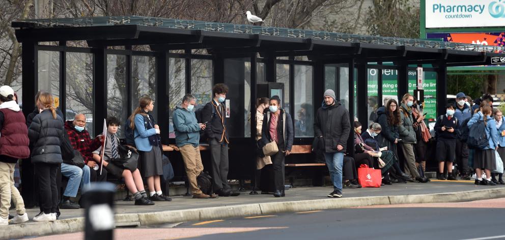 Passengers wait at the Bus Hub on Tuesday after a rising tide of cancellations. PHOTO: PETER...