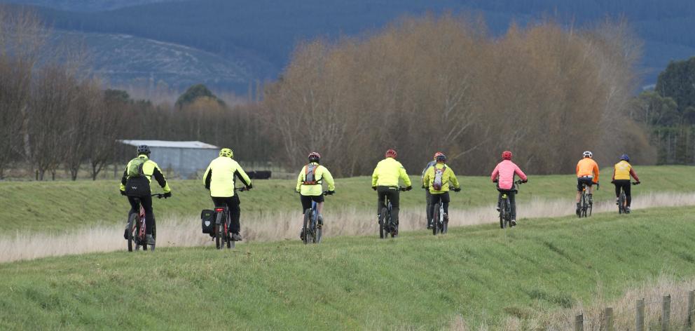 Riding on a stopbank beside Silver Stream near Mosgiel yesterday are members of the AOK Shark...